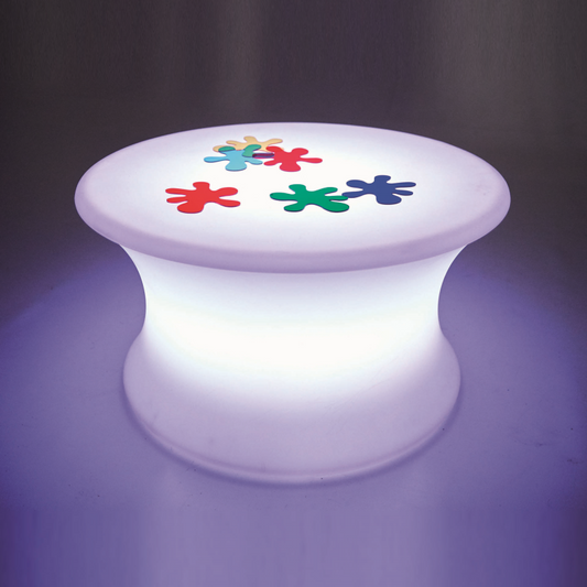 Colorful flower designs on a glowing white table against a dark background