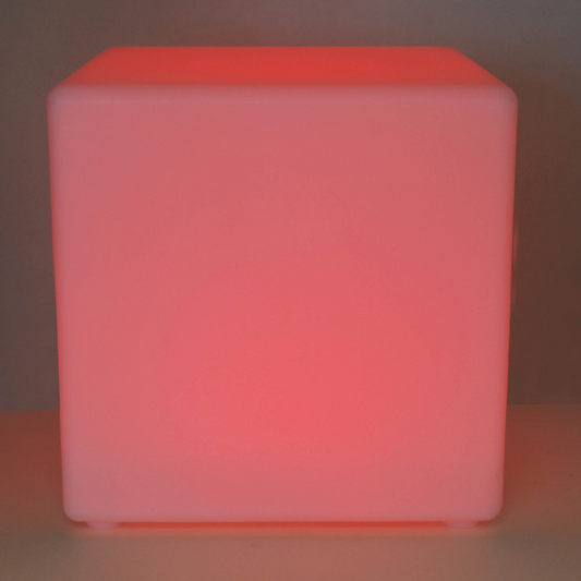 Pink cube-shaped light on a dark background