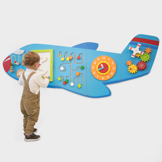 Child playing with a colourful airplane-shaped educational toy on a white background