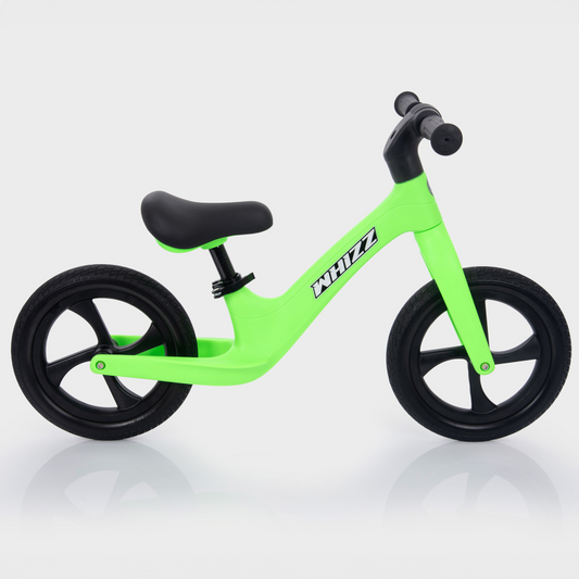 Green balance bike with black wheels on a white background