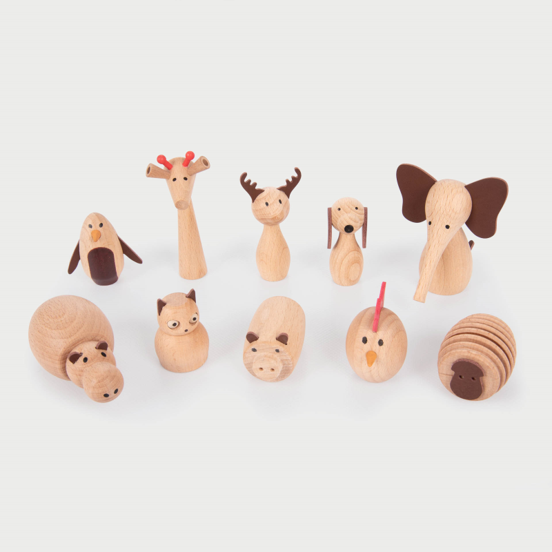 Set of wooden animal figurines on a light gray background