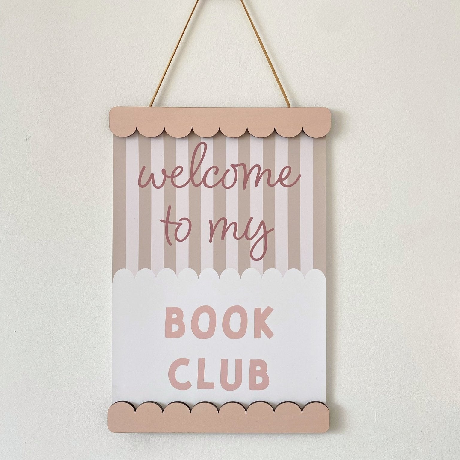 Decorative sign with 'welcome to my book club' text on a striped background