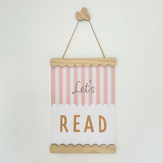 Decorative sign with 'Let's Read' text on a white background