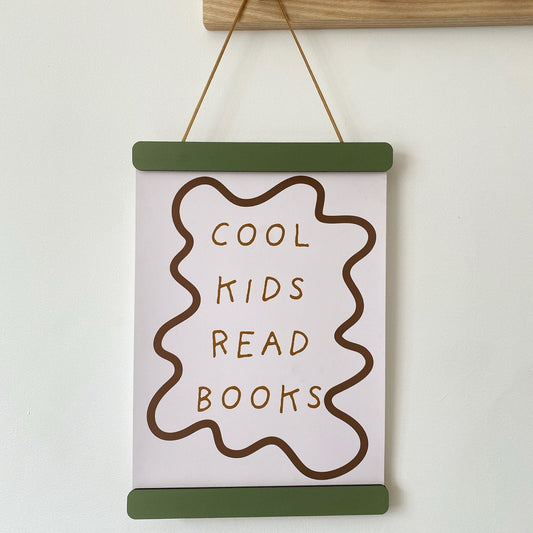 Hanging sign with 'Cool kids read books' text on a white wall