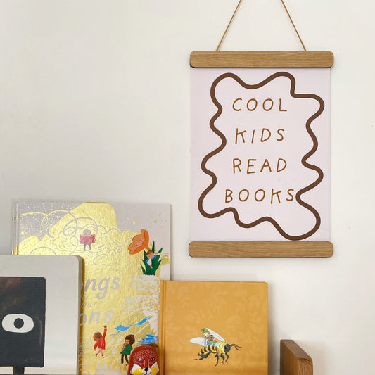 Wooden shelf with books and a framed poster on a white wall