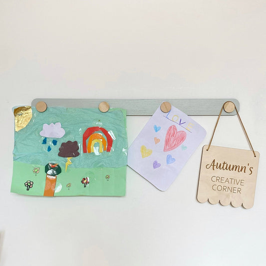 Children's art on a art display bar