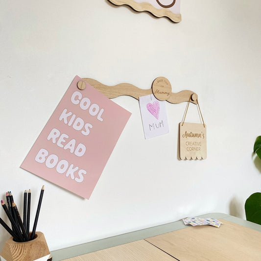 Wooden pegboard with motivational signs on a white wall
