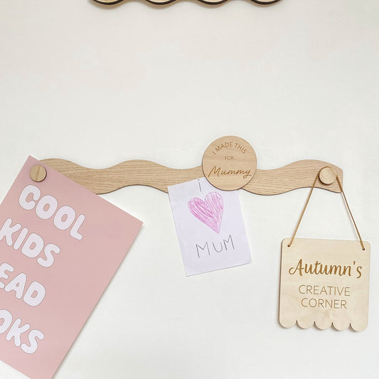 Wooden peg board with hanging signs on a white background