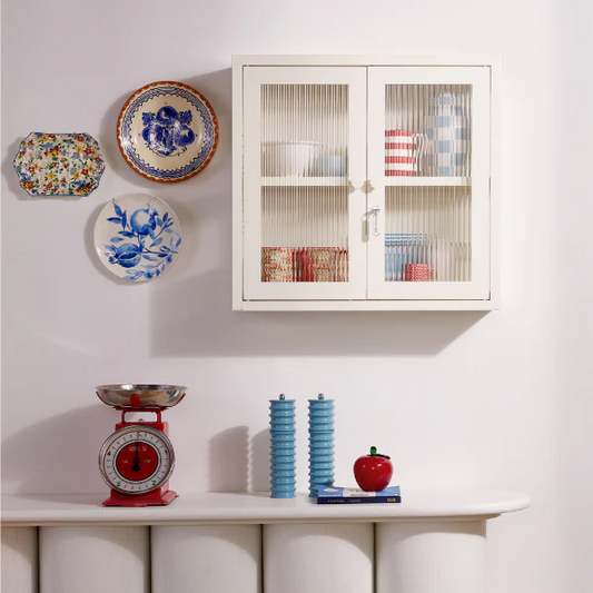 White cabinet on wall with decorations