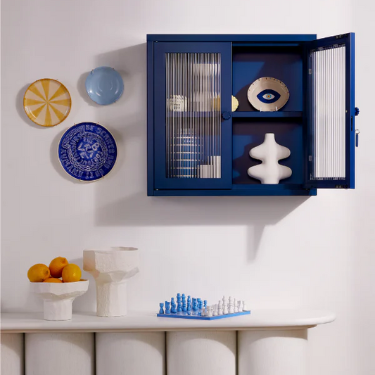 Navy cabinet with a door open hung on wall with decor