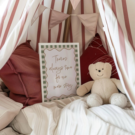 Children's room with a teddy bear, framed quote, and striped canopy.