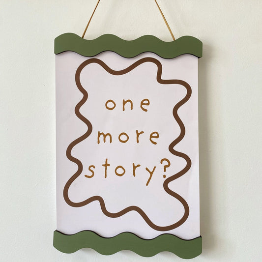 Decorative sign with 'one more story?' text on a white background